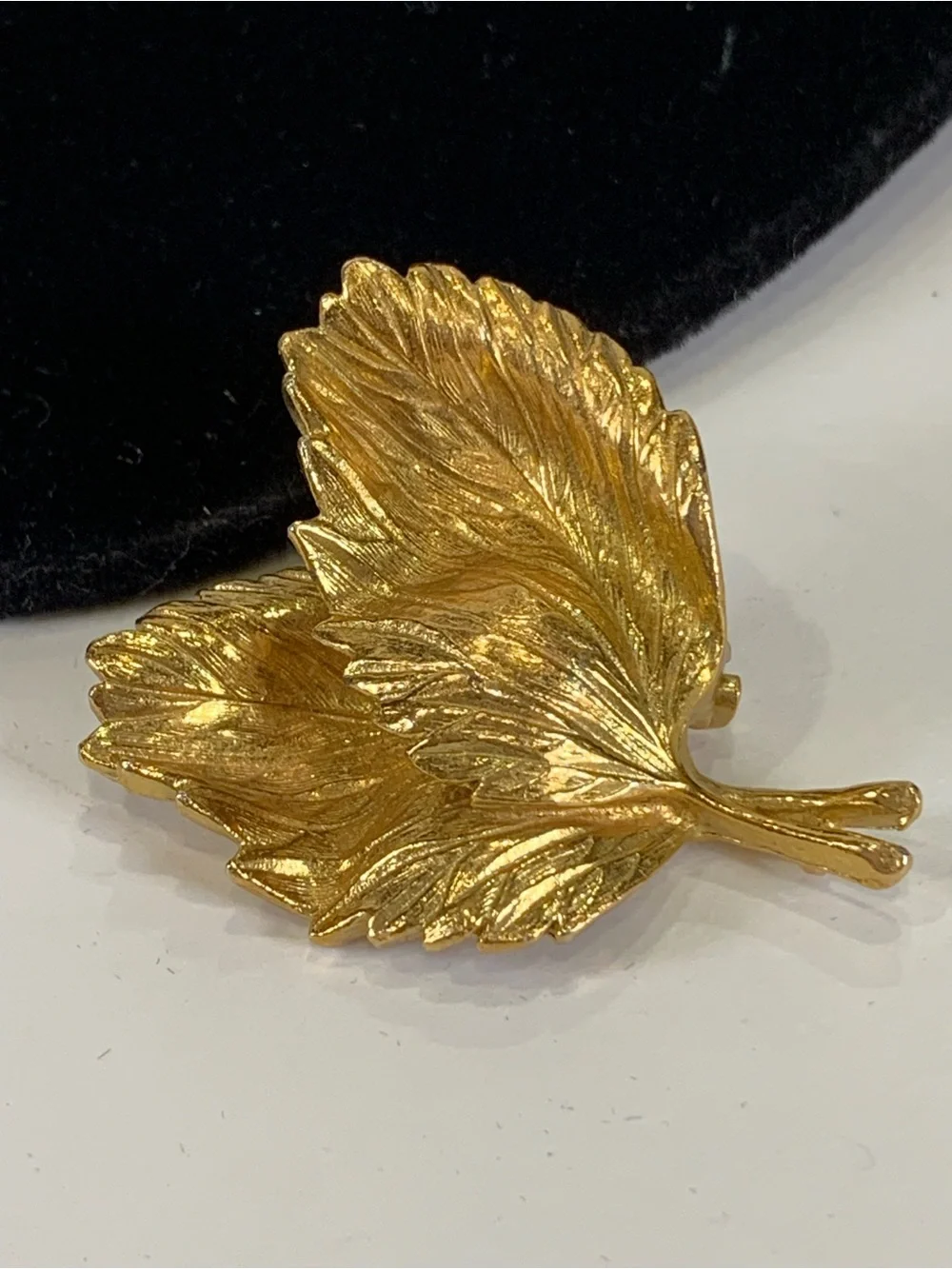 Beautiful vintage Marvella brooch in the shape of a curled leaf, done in brushed